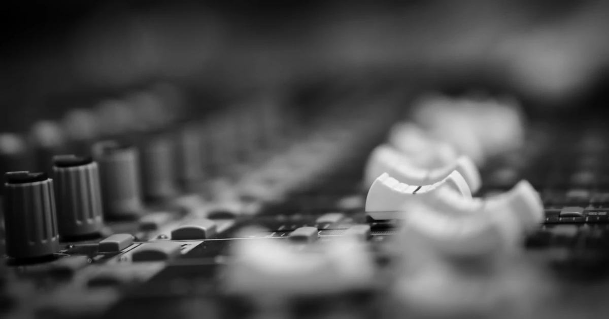 Close-up of an audio mixing console.