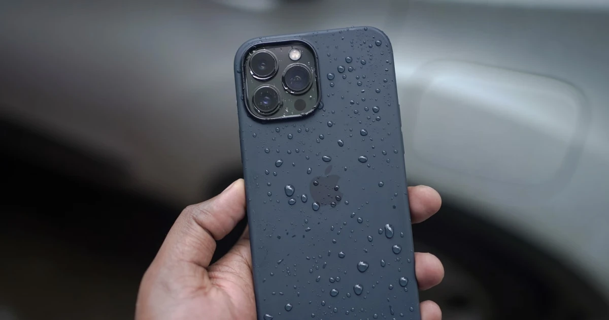 A smartphone beside water droplets after accidental water exposure