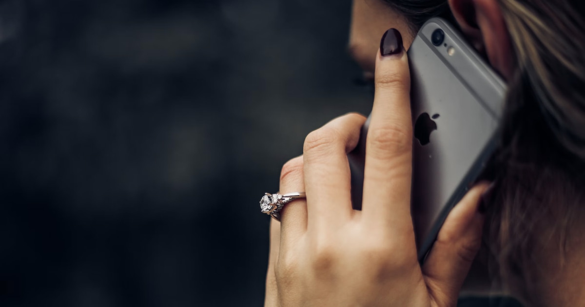 Woman holding an iPhone to her ear during a call.
