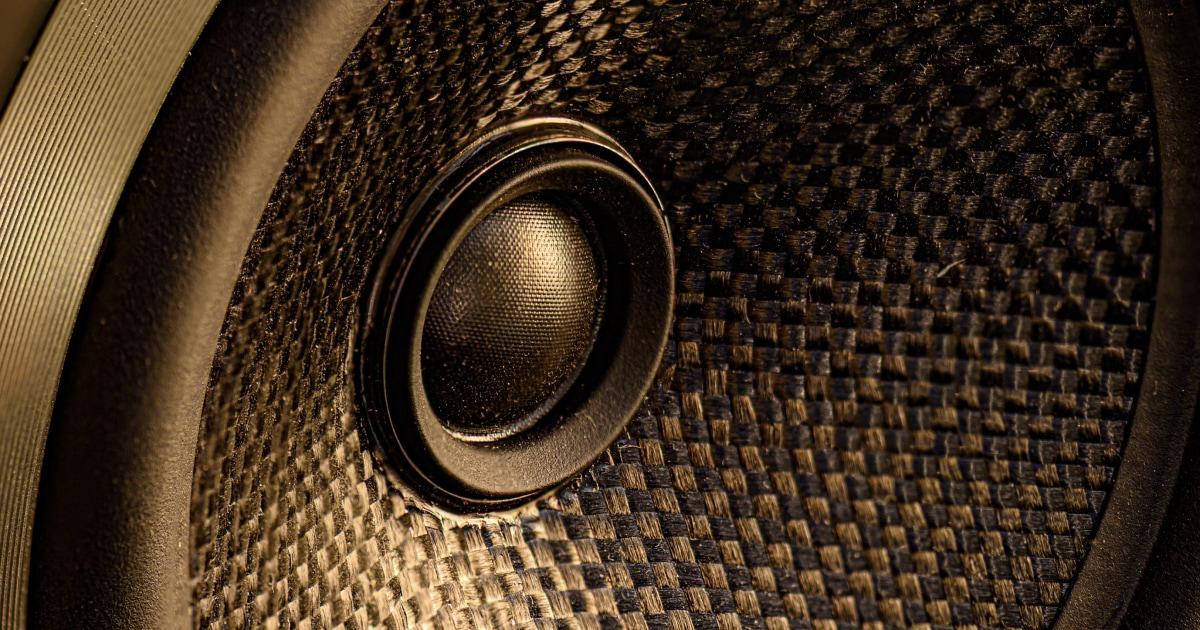 Close-up of a speaker cone with a woven fabric grille.