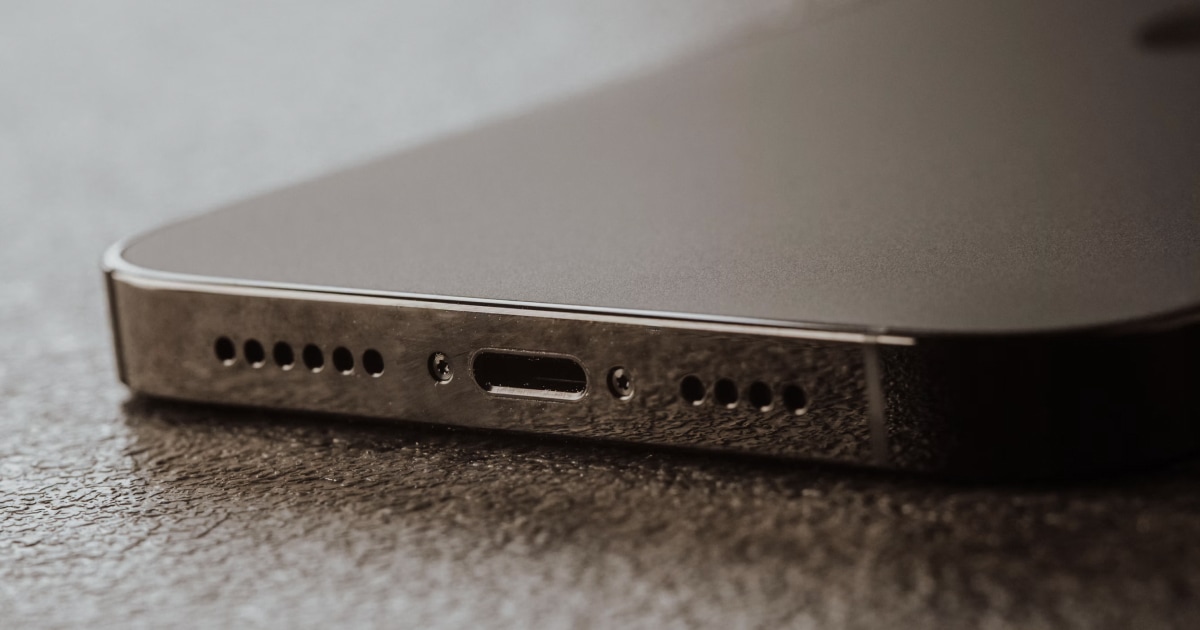 Close-up of an iPhone's bottom edge showing the speaker grille and charging port.