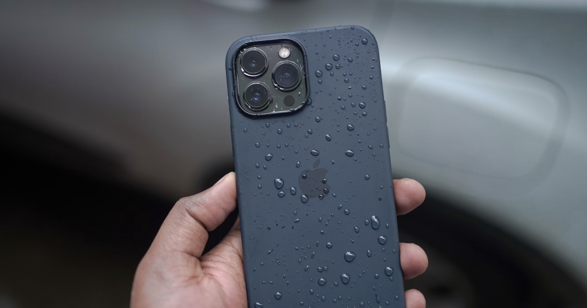 A smartphone beside water droplets after accidental water exposure